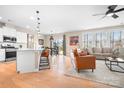 Open-concept living room with hardwood floors, modern furnishings, and an eat in kitchen at 2024 Linn Cv, Waxhaw, NC 28173