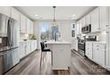 Bright kitchen features an island with a breakfast bar, modern appliances, and sleek cabinets at 2132 Electric Ln, Charlotte, NC 28205
