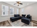 Bright living room featuring hardwood floors, recessed lighting, and a stylish sectional couch at 2132 Electric Ln, Charlotte, NC 28205