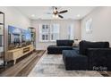 Bright living room featuring hardwood floors, recessed lighting, and a stylish sectional couch at 2132 Electric Ln, Charlotte, NC 28205