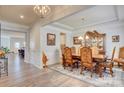 Elegant dining room with hardwood floors, chandelier, and a decorative china cabinet at 2598 Bryant Dr, Fort Mill, SC 29707