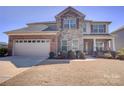 Beautiful two-story home with brick and stone exterior, two car garage, and well-manicured front lawn at 2598 Bryant Dr, Fort Mill, SC 29707