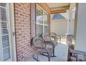 Inviting front porch with rocking chairs, brick pillars, and a view of the neighborhood at 2598 Bryant Dr, Fort Mill, SC 29707