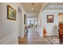 Spacious hallway with hardwood floors, elegant wainscoting, and views into the living spaces at 2598 Bryant Dr, Fort Mill, SC 29707