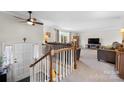 Spacious living room with staircase, neutral walls, ceiling fan, and comfortable seating at 3808 22Nd Street Ne Ct, Hickory, NC 28601