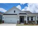 Charming single-story home featuring a two-car garage and inviting front porch at 407 Sunharvest Ln, Indian Trail, NC 28079