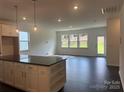 Open-concept living room featuring large windows, recessed lighting, and dark hardwood floors at 407 Sunharvest Ln, Indian Trail, NC 28079