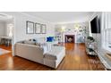 Bright living room with hardwood floors, a cozy fireplace, and a comfortable sectional sofa at 4425 Longwood Dr, Charlotte, NC 28209