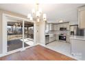 Beautifully updated kitchen featuring stainless steel appliances, and modern cabinetry, with an adjacent dining area and sliding door to deck at 4836 Cheviot Rd, Charlotte, NC 28269