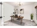 Stylish home office with a modern desk, shelving, and ample natural light for a productive workspace at 5672 Wrenfield Ct, Charlotte, NC 28277