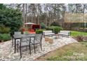 Outdoor patio area with stone ground and seating is perfect for entertaining or relaxing at 5672 Wrenfield Ct, Charlotte, NC 28277