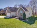Charming brick home with well-maintained lawn and inviting front porch at 572 Church St, Locust, NC 28097