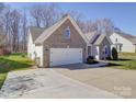 Charming brick home with well-maintained lawn, two-car garage, and inviting front porch at 572 Church St, Locust, NC 28097