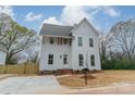 Beautiful two-story home with white siding, a well-kept yard, and a welcoming front entrance at 576 Reid St, Belmont, NC 28012