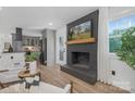 Inviting living room with a modern fireplace, an open layout and wood flooring at 7215 Kilcullen Dr, Charlotte, NC 28270