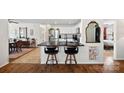 Open kitchen features black countertops, breakfast bar seating, and stainless steel appliances at 8408 Williamsburg Cir, Huntersville, NC 28078