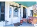 Inviting front porch features wicker seating and a charming wreath on the front door at 881 Saluda Rd, Chester, SC 29706