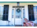 Close-up of the front porch, showing the entrance with a wreath and seating area at 881 Saluda Rd, Chester, SC 29706