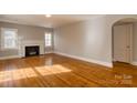 Bright living room featuring gleaming hardwood floors, a fireplace, and natural light at 904 Maple Ave, Salisbury, NC 28144