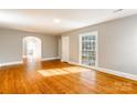 Open living room with hardwood floors and large windows letting in natural light at 904 Maple Ave, Salisbury, NC 28144