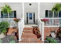 Inviting front porch with brick steps and decorative planters creates a warm welcome at 932 Dovefield Dr, York, SC 29745