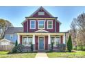 Charming two-story home with a welcoming front porch and beautiful landscaping at 106 Orange St, Charlotte, NC 28205