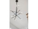 Modern chandelier with spherical glass shades and black and silver accents, adding a touch of elegance to the home at 12202 Anne Blount Aly, Davidson, NC 28036