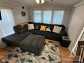 Comfortable living room featuring a sectional sofa, patterned rug, and natural light at 134 Cardinal Ave, New London, NC 28127