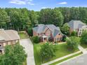 High angle of property with mature landscaping, a long driveway, and tree-lined streets at 14314 Lissadell Cir, Charlotte, NC 28277