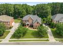 Aerial view of home with mature trees surrounding the property and a long driveway at 14314 Lissadell Cir, Charlotte, NC 28277