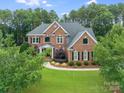 Beautiful two-story brick home with lush front lawn and mature landscaping at 14314 Lissadell Cir, Charlotte, NC 28277