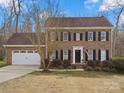 Classic brick home with an attached garage, manicured lawn, and traditional colonial-style architecture at 14723 Sapphire Ln, Pineville, NC 28134