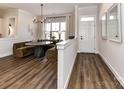 Stylish dining area featuring a unique round table with booth seating and modern lighting at 15140 Rocky Bluff Loop, Davidson, NC 28036