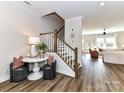 Welcoming foyer with hardwood floors, staircase, and tasteful decor at 15140 Rocky Bluff Loop, Davidson, NC 28036