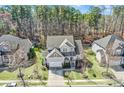 An aerial view of a home nestled among mature trees, showcasing its roof, yard, and surrounding neighborhood at 17609 Caddy Ct, Charlotte, NC 28278