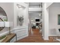 Grand foyer featuring hardwood floors, a staircase, and views of the living room with fireplace at 2711 Liberty Hall Ct, Waxhaw, NC 28173