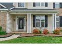 Inviting front porch with elegant columns, adorned with lush landscaping and stylish outdoor seating at 2711 Liberty Hall Ct, Waxhaw, NC 28173