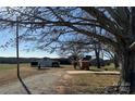 Expansive backyard features open fields, outbuildings, and mature trees, offering privacy and space at 3423 Crowder Ridge Rd, Shelby, NC 28150