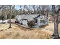 Beautifully landscaped property featuring a charming home with a deck, mature trees, and an expansive yard at 422 Lee Ave, Wadesboro, NC 28170