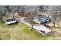 Spacious property featuring a well-maintained house, ample parking, detached garage, and mature trees on a large lot at 422 Lee Ave, Wadesboro, NC 28170