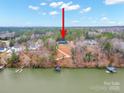 Aerial view of a lakefront house featuring a private dock and wooded surroundings at 4890 Rio De Luna None, Hickory, NC 28601