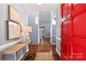 Inviting foyer with hardwood floors, a bright red door, and elegant decor at 5101 Gamton Ct, Charlotte, NC 28226