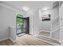 Open entryway featuring a black front door, fresh paint and wood-look flooring at 6846 Colonial Garden Dr, Huntersville, NC 28078