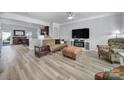 Open-concept living room features a fireplace, neutral walls, and view to the kitchen at 6846 Colonial Garden Dr, Huntersville, NC 28078