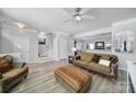 Spacious living room with light-colored flooring, ceiling fan, and staircase to upper level at 6846 Colonial Garden Dr, Huntersville, NC 28078