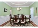 Formal dining room featuring wainscoting and decorative lighting at 7343 Mill Ruins Sw Ave, Concord, NC 28025