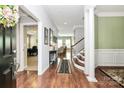 Spacious foyer with hardwood floors and elegant staircase at 7343 Mill Ruins Sw Ave, Concord, NC 28025