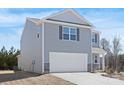 Two story home with gray siding, white trim, shutters, a two car garage, and stone accents at 808 N Naughton St, Chester, SC 29706
