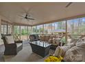 Spacious outdoor porch featuring comfortable seating, a ceiling fan, and a wooded view at 1025 Seminole Dr, Waxhaw, NC 28173
