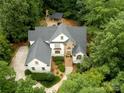 Aerial view of the home, landscaped yard and patio with outdoor fireplace and bar at 1025 Seminole Dr, Waxhaw, NC 28173